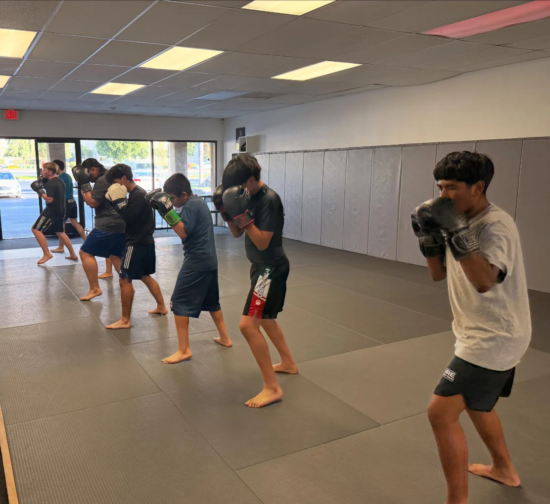 Youth boxing student practicing footwork and guard